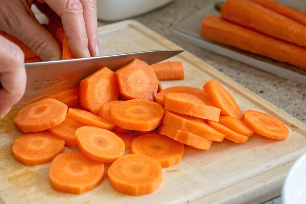 Authentic Moroccan Spiced Carrots Recipe: A Flavorful Side Dish to Elevate Your Meals 6 slice the carrots in circles with human hand and k 1 edited www.moroccaneats.com